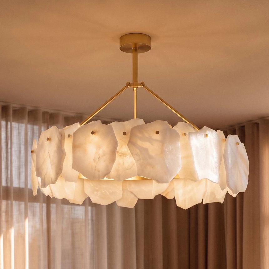 A lit petal ring hung in front of long curtains in a living room