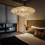 The shade lit above a bed with a wide headboard and a screened window behind