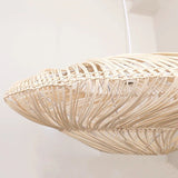 The edge of the shade seen close, the rattan strands bound at the rim
