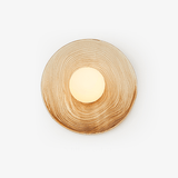 Round ceramic wall light with a cream and caramel ringed glaze around an opal globe