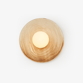 Round ceramic wall light with a cream and caramel ringed glaze around an opal globe