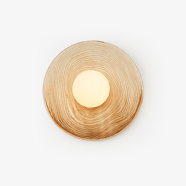 Round ceramic wall light with a cream and caramel ringed glaze around an opal globe
