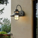 The light on a pale render wall above a bench and a garden beyond