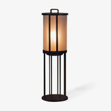 Frosted acrylic column lantern on a tall four leg floor stand in black