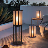Lanterns lit on a timber deck beside a yucca and a lounger at night