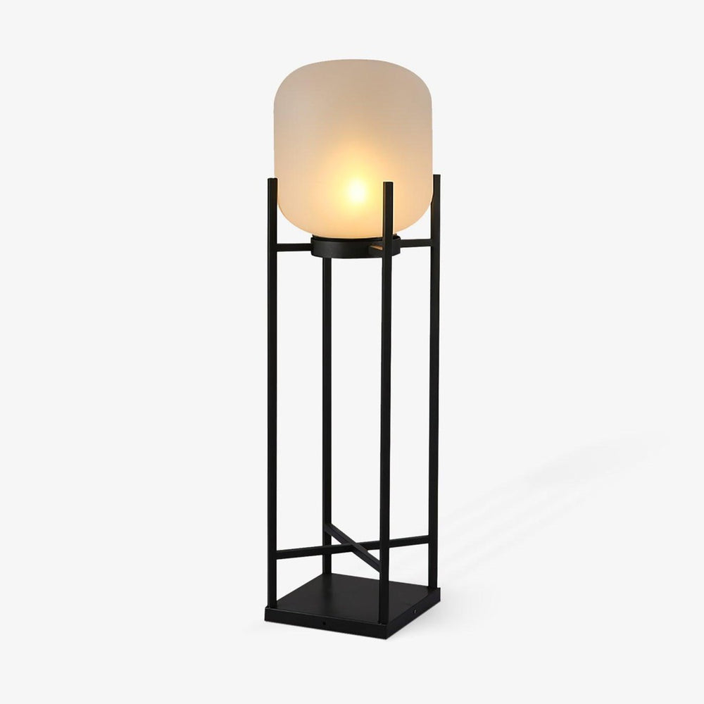 Opal cylinder shade resting in an open square steel stand in black