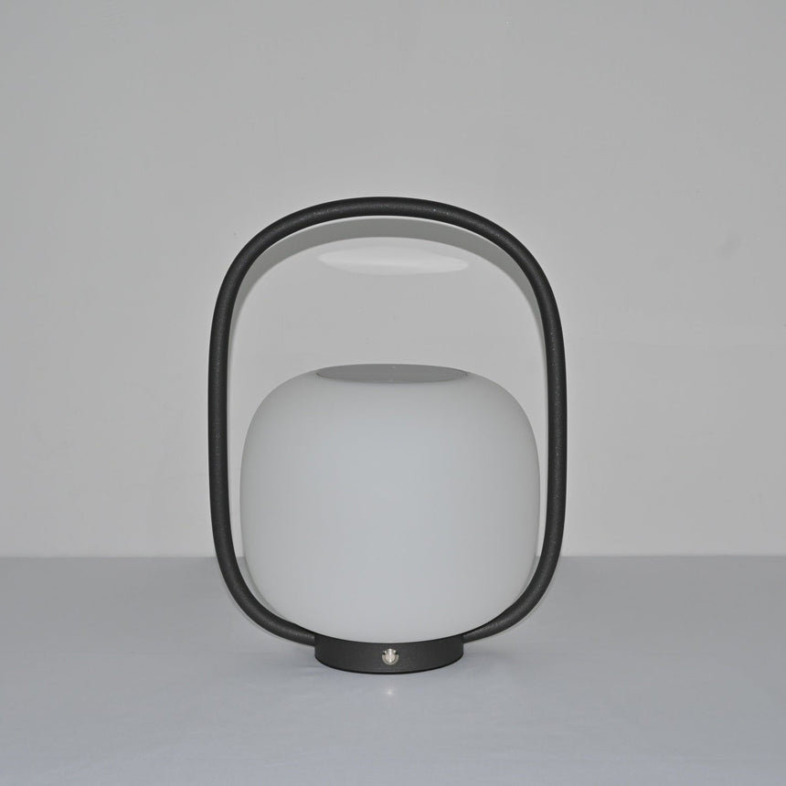 The lamp unlit, the matte globe and the arch handle seen in daylight