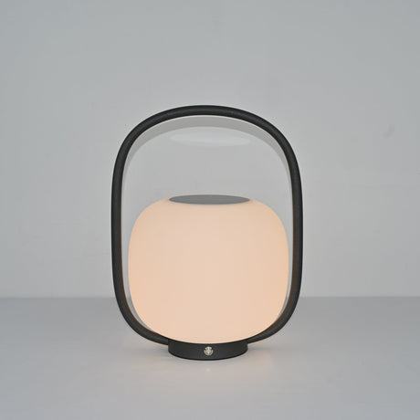 The lamp lit at a warm setting, the globe glowing inside the dark arch