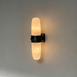 The matte black version with its lit tube on a pale background