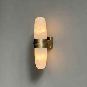 The brass version with its lit tube, seen on a gray background