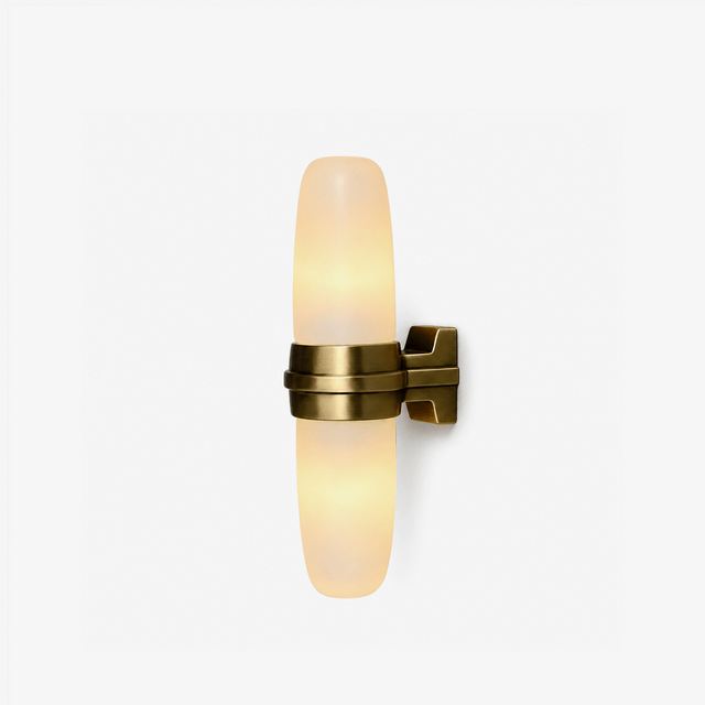 Slim oval wall sconce with a lit stone tube held by a brass bracket