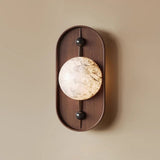 Close view of the lit stone look disc where the two pins hold it