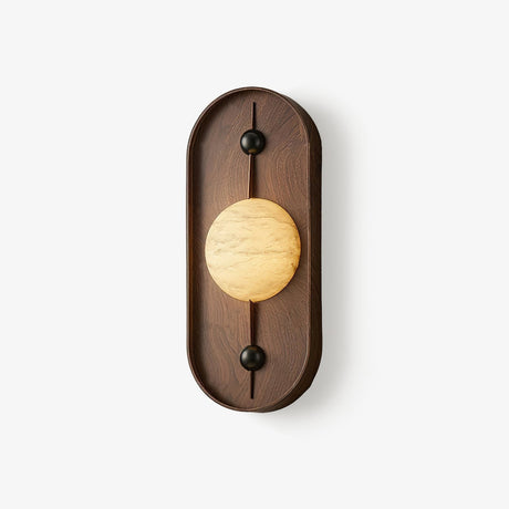 Oval wall sconce, a walnut pill frame holding a pale stone look disc