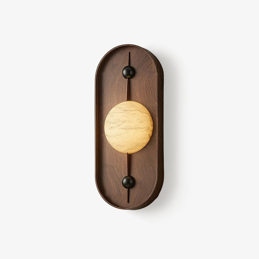 Oval wall sconce, a walnut pill frame holding a pale stone look disc