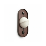 The narrow walnut pill with a white sphere held between its two pins