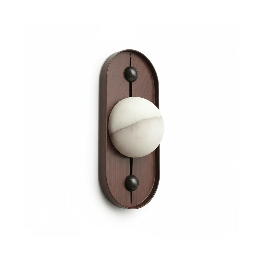 The narrow walnut pill with a white sphere held between its two pins