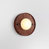 The round walnut plate version with a pale disc set proud of its face