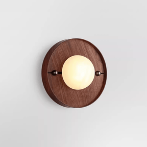 The round walnut plate version with a pale disc set proud of its face