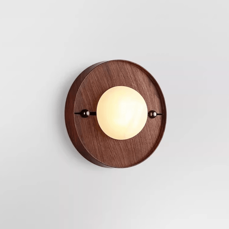 The round walnut plate version with a pale disc set proud of its face