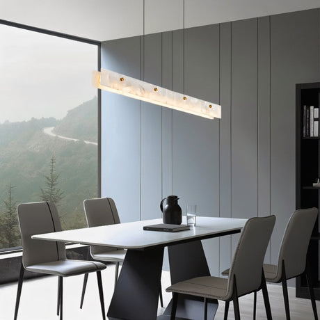 The lit bar above a dining table with chairs and a window onto the hills