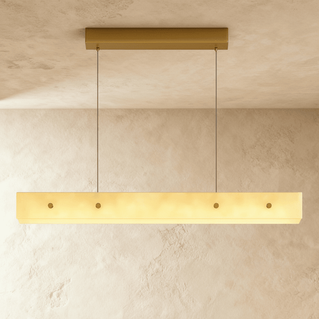 A slim alabaster bar lit on two cables below a long brass canopy