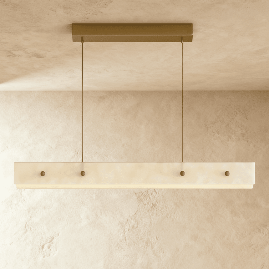 The same slim alabaster bar unlit, four brass bolts set along its face