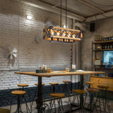Lit over a cafe table and stools against a painted brick wall