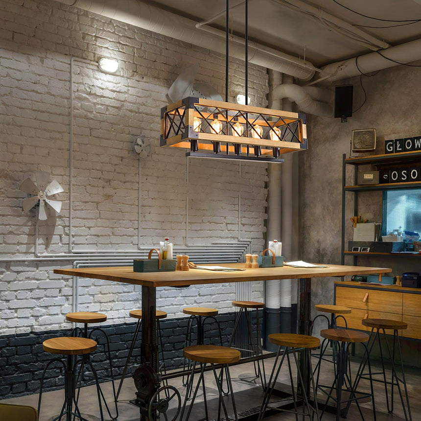 Lit over a cafe table and stools against a painted brick wall