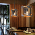 Two of the small cube version lit above tables in a timber lined room