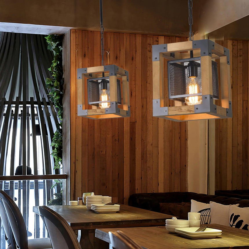 Two of the small cube version lit above tables in a timber lined room