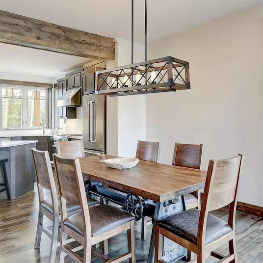 Lit above a wood dining table and dark chairs under an exposed beam