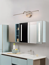 Lit over a mirrored bathroom cabinet above a basin and a pale blue vanity unit