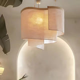 Close view of the overlapping shades lit against a curved plaster wall