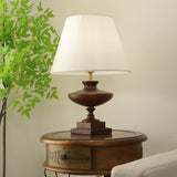 Walnut oversized table lamp seen from the front, urn base and plinth