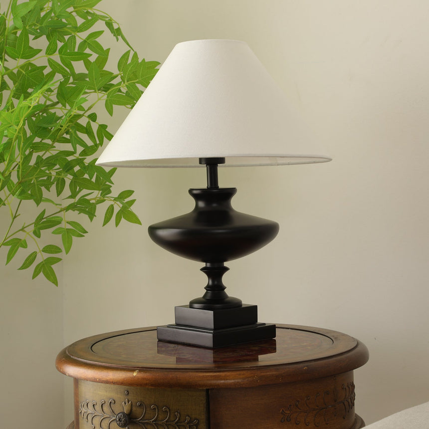 Walnut oversized table lamp seen low, the stepped plinth in the foreground