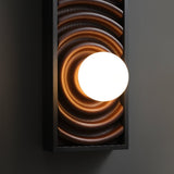 The carved rings running out from the glass orb across the wood face
