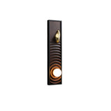Walnut panel carved in ripples inside a black frame with the orb lit below