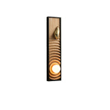 Light ash panel carved in ripples inside a black frame, the orb lit at the base
