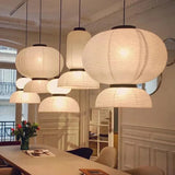 Four rice paper lanterns at different sizes hung as a cluster