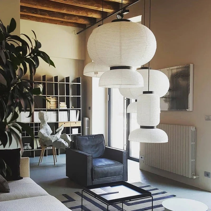 Paper pendant lamp in layered rice paper, three lanterns lit in a living room