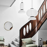 Two rice paper lanterns hung over a wooden staircase