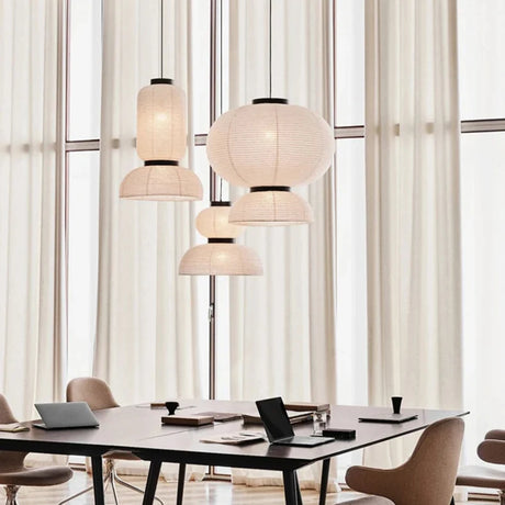 Rice paper lanterns hung above a table in a bright room with curtains