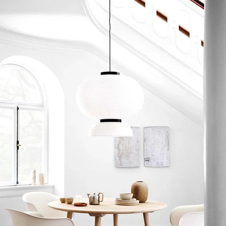 Rice paper lantern hung in a white room with an arched window