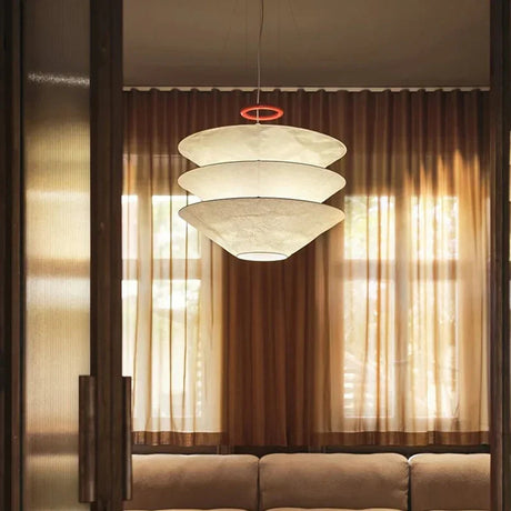 Layered paper shade hung in front of long curtains