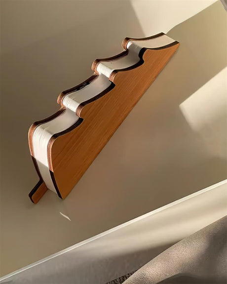 The lamp folded shut, showing the tree shaped wood cover on one side