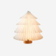 Paper table lamp opened into a white folding tree on a wood base