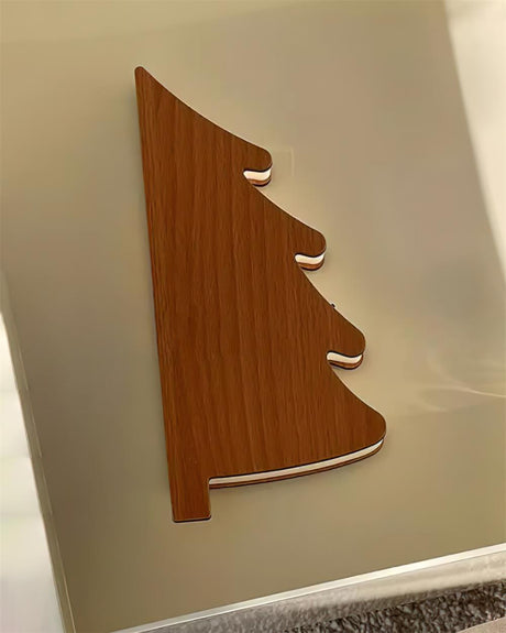 Close view of the tree shaped wood cover that closes over the paper
