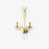 Gold wall sconce with two candle arms, scrolled top, pearl chains and crystal drops