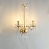 The pearl sconce lit warm, the candle bulbs glowing above the crystal drops