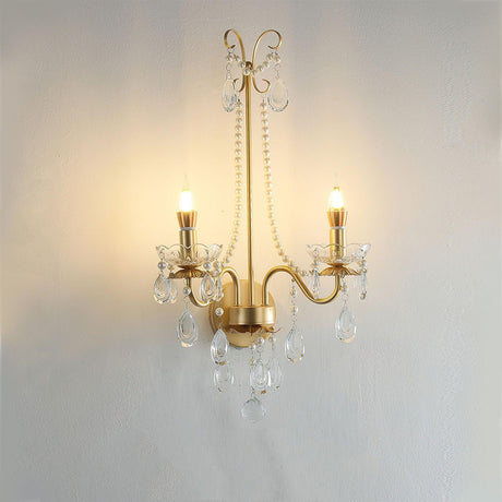 The pearl sconce lit warm, the candle bulbs glowing above the crystal drops
